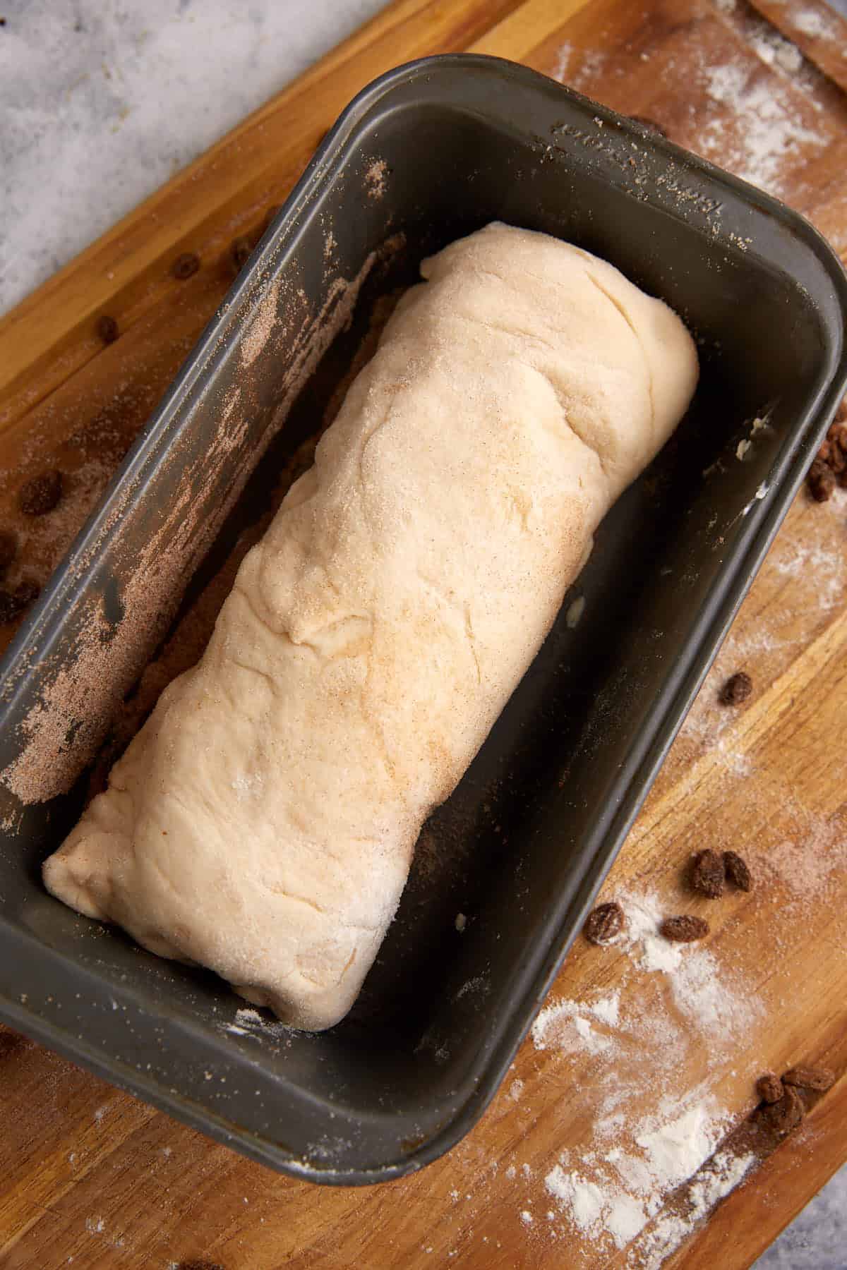 A roll of cinnamon raisin bread before it has risen.
