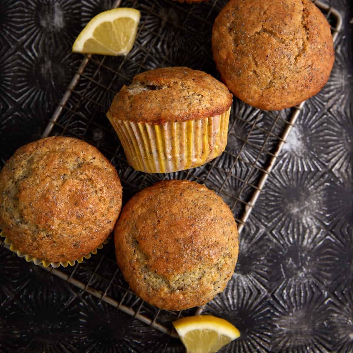Lemon poppy seed muffins on a cooling rack.