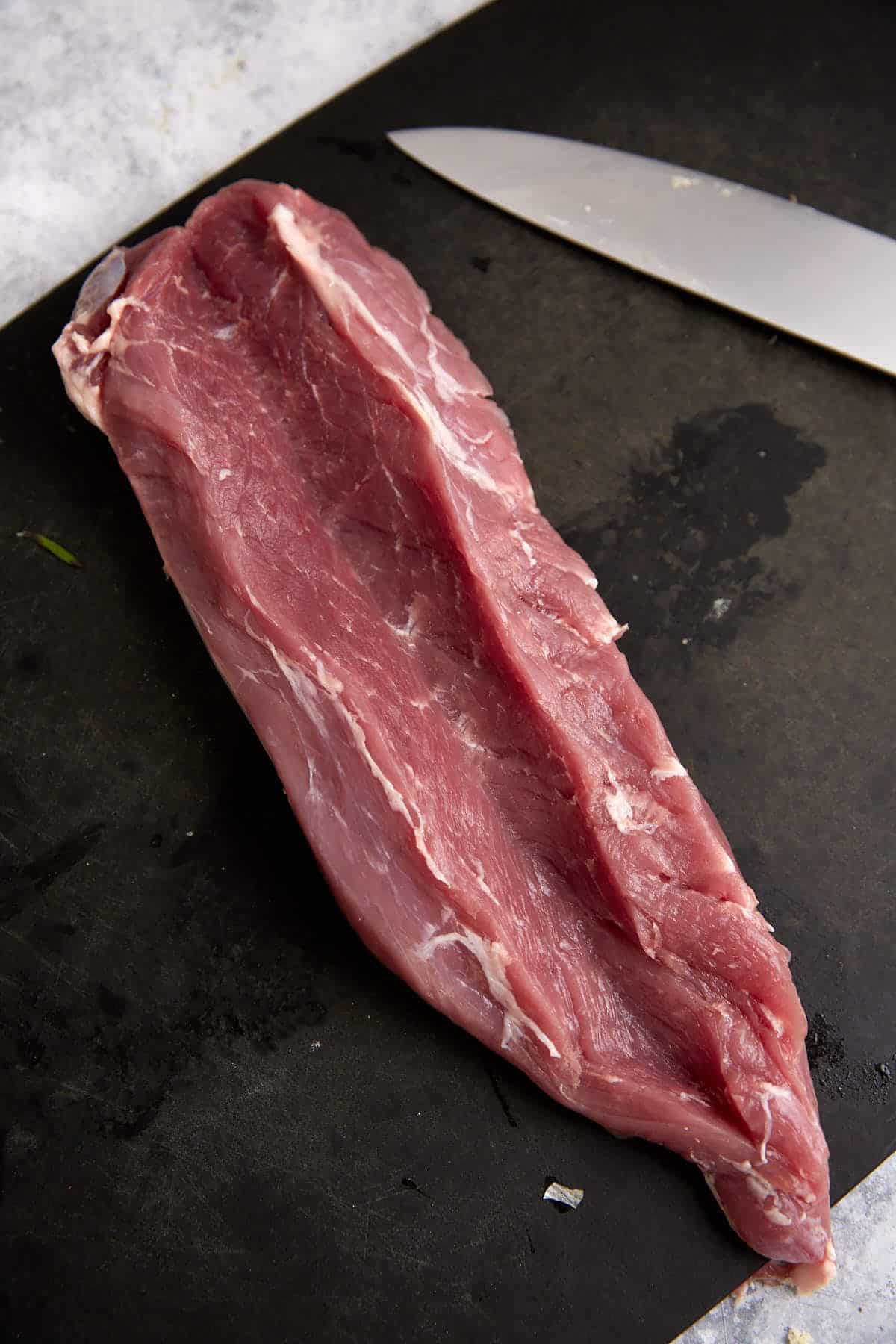 A slit cut down a pork tenderloin.