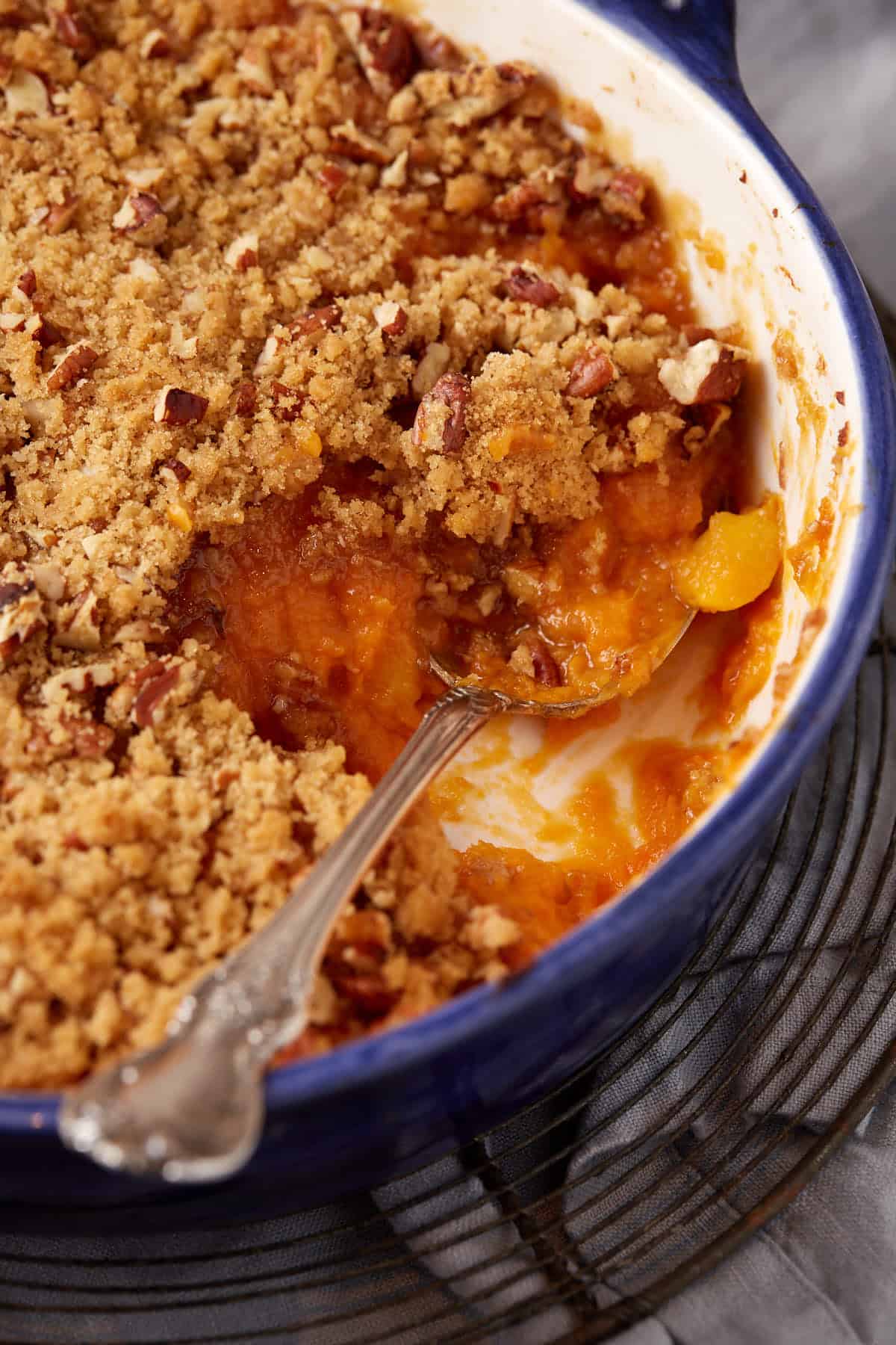 A serving spoon in a sweet potato casserole.