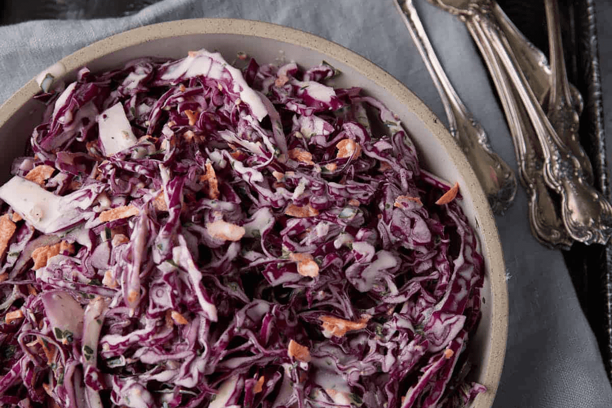 Red cabbage coleslaw in a serving bowl.