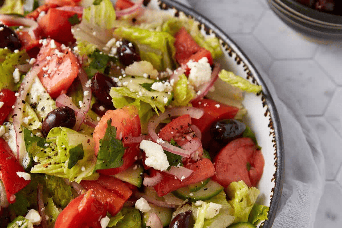 Greek cucumber salad in a serving bowl.