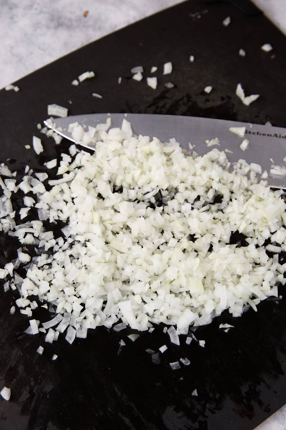 Chopped onions on a cutting board.