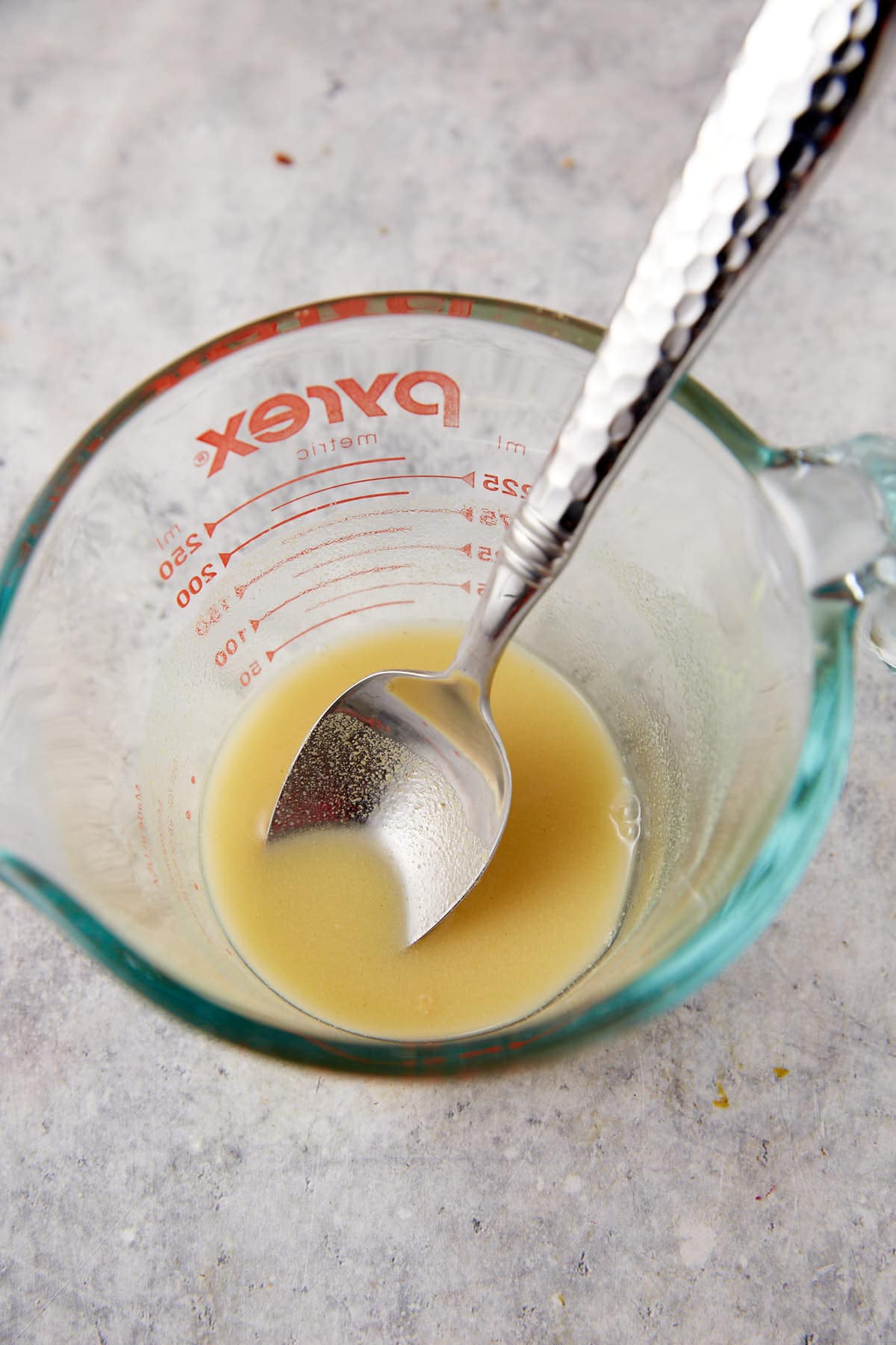 Dry mustard with water in a measuring cup.