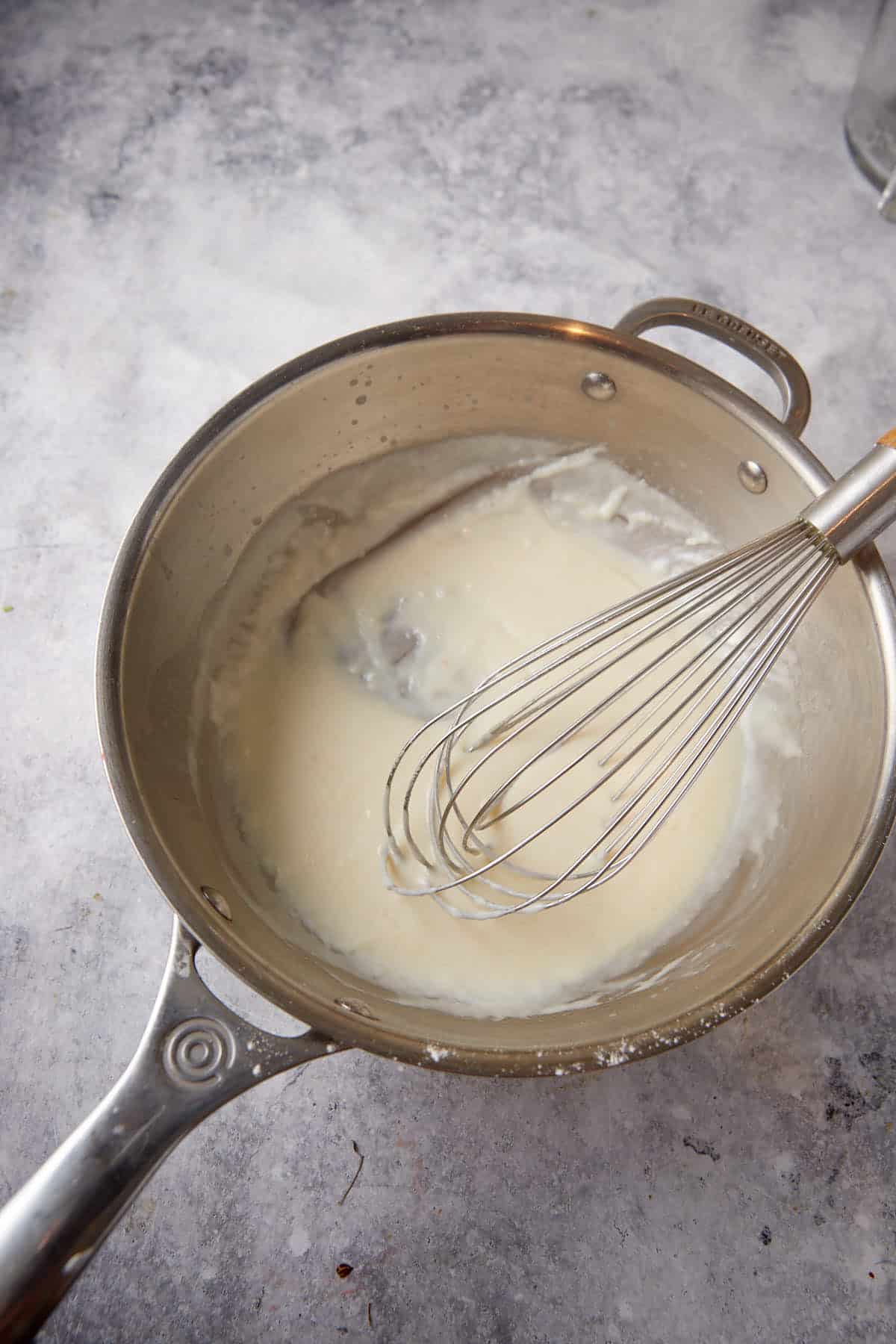 A roux of flour and butter in a saucepan.