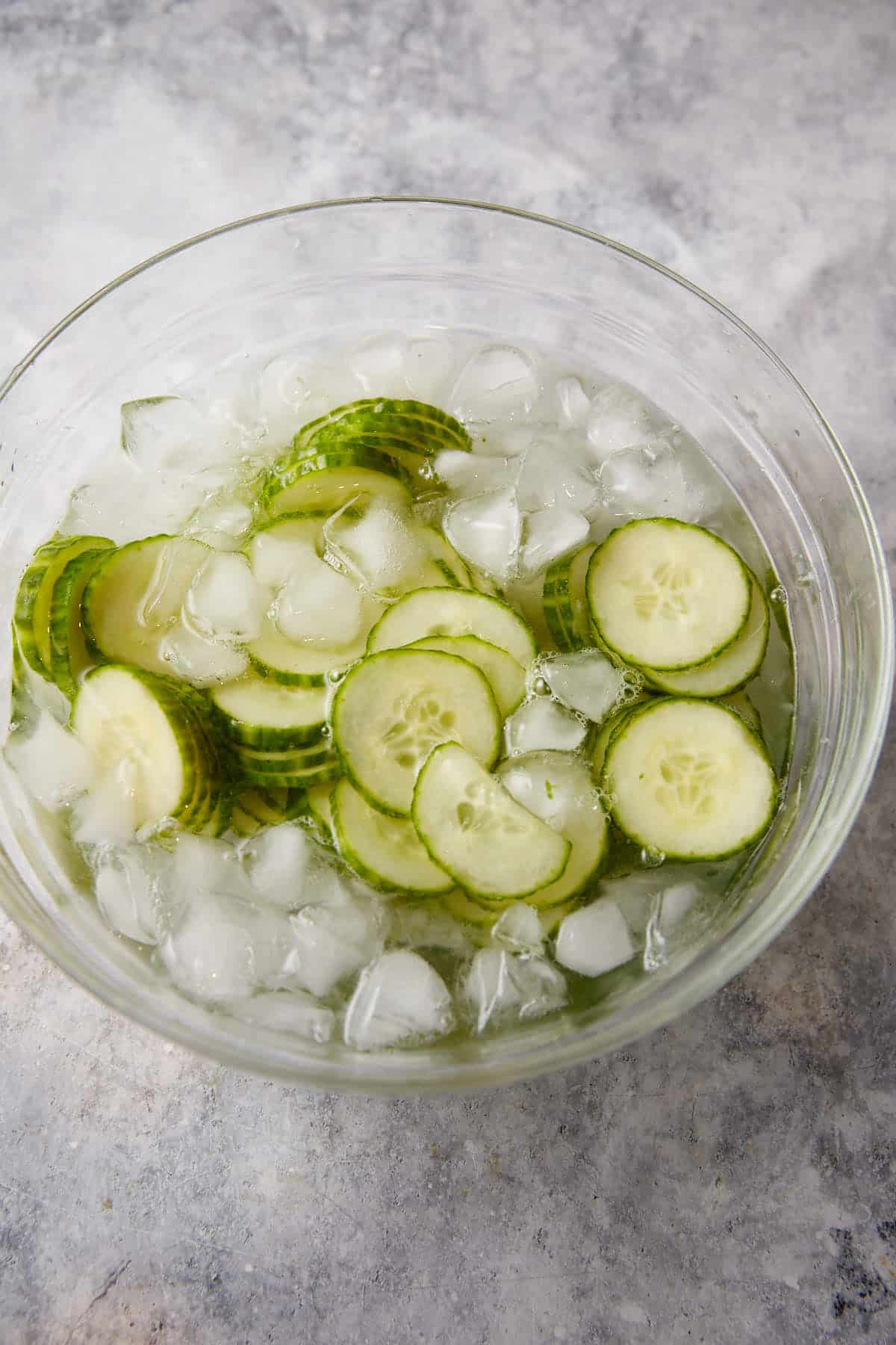 Cucumbers in a bowl of ice water.