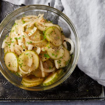 A cucumber vinegar salad in a glass bowl.