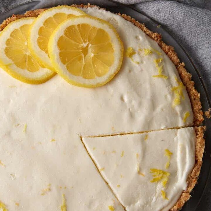 A lemon chiffon pie with a slice cut out.
