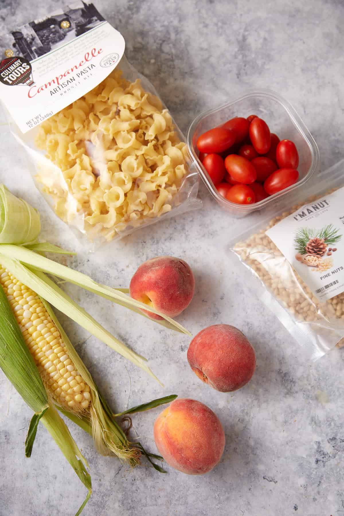 The ingredients for a peach pasta salad.