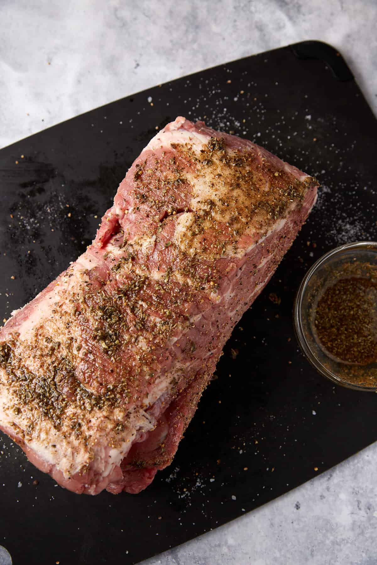 A pork shoulder covered in a rub.