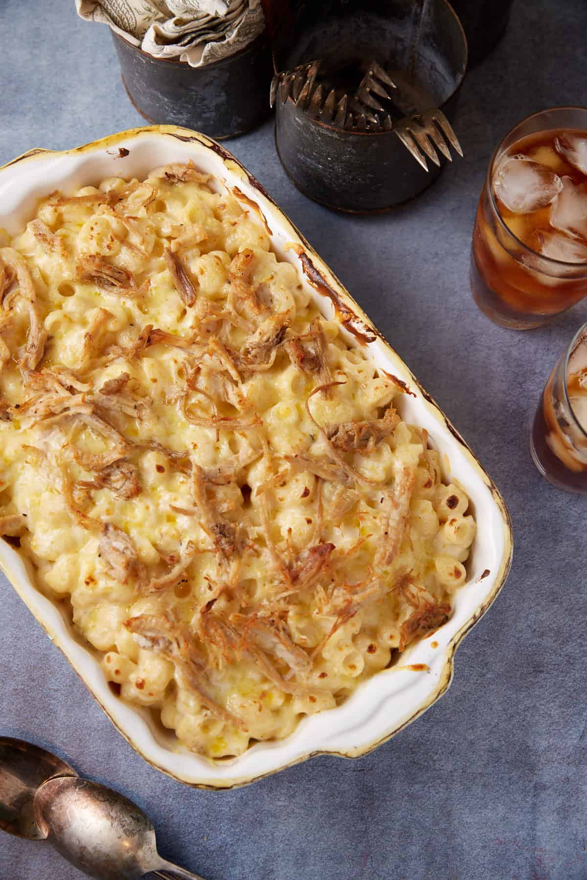 A casserole dish of baked pulled pork mac and cheese.