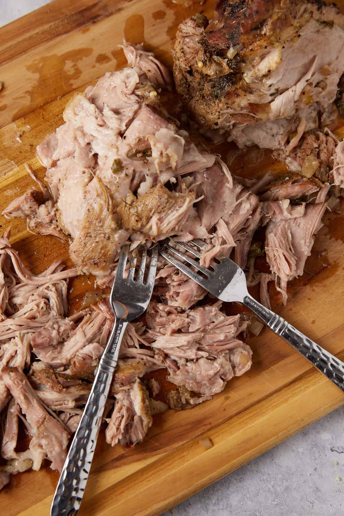 Shredded pork on a cutting board.