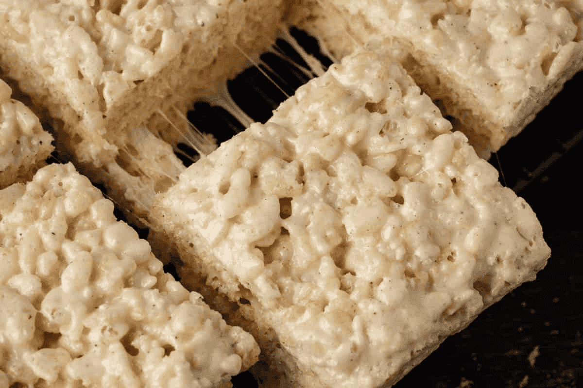 A batch of rice krispie cookies after being cut into squares.