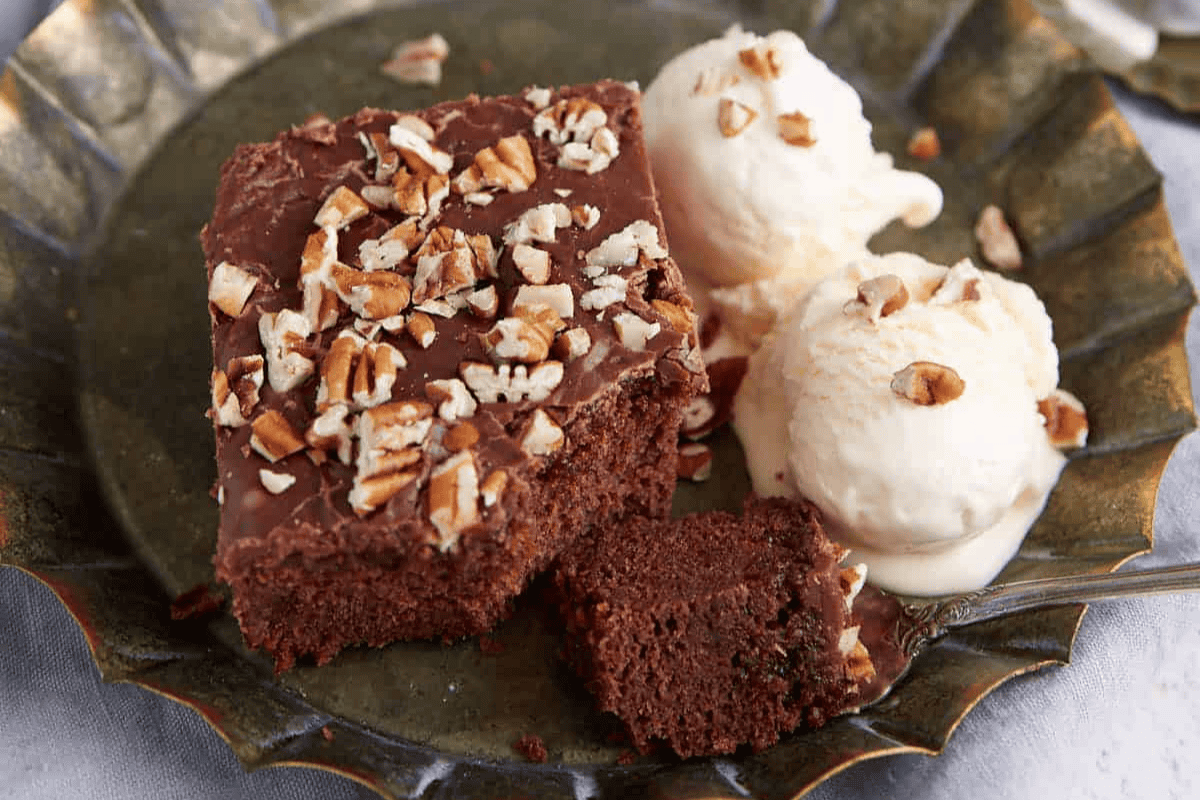 A piece of coca-cola cake with ice cream.