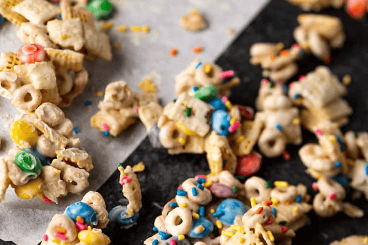 White chocolate chex mix on parchment paper.