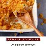 Chicken potato casserole in a baking dish with a wooden spoon.