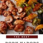 A platter of pork kabobs with peaches.
