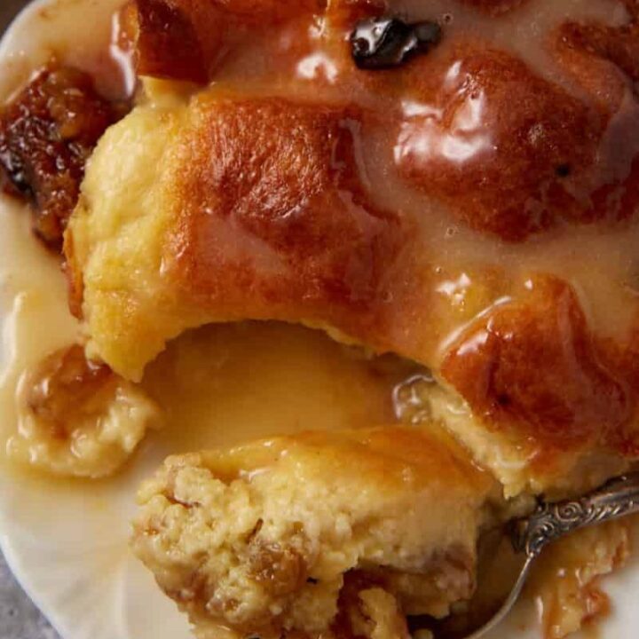 A serving of bread pudding with a spoon.