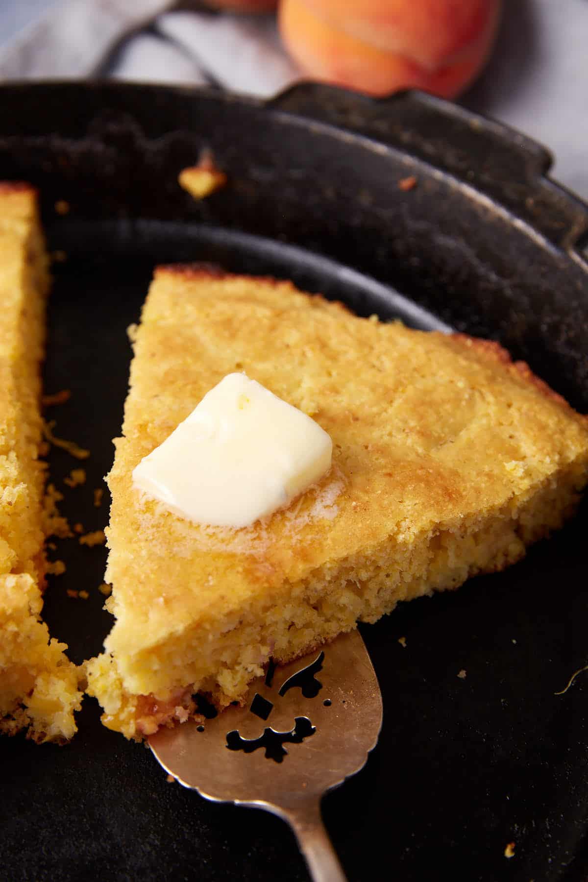 Butter melting on a piece of cornbread.