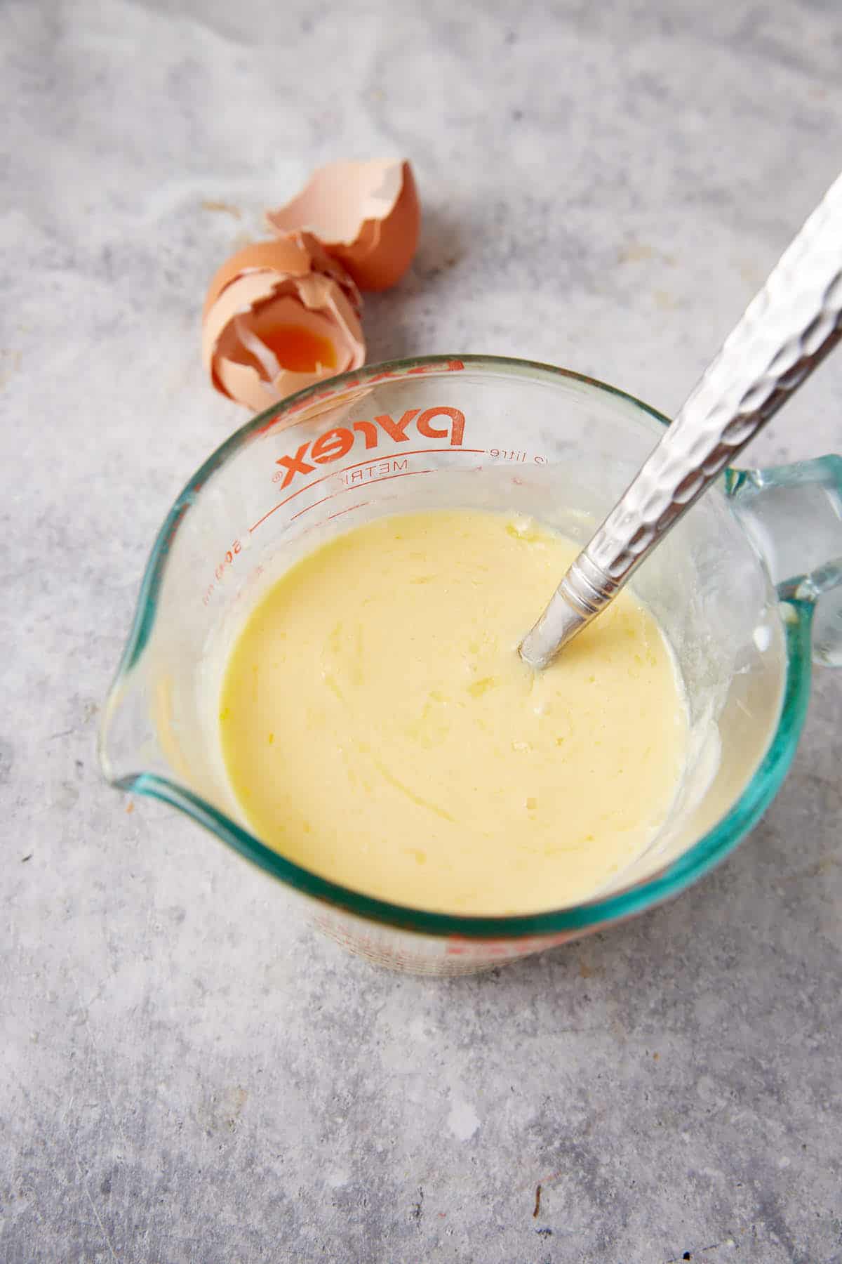 Liquid ingredients for cornbread in a bowl.