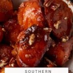 Close-up image of glazed skillet sweet potatoes garnished with pecan pieces, showcasing their shiny, caramelized coating.