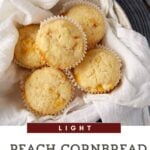 A basket lined with a white cloth contains five light peach cornbread muffins with visible peach pieces. Text below the basket reads, "Light Peach Cornbread Muffins - Made with fresh peaches.