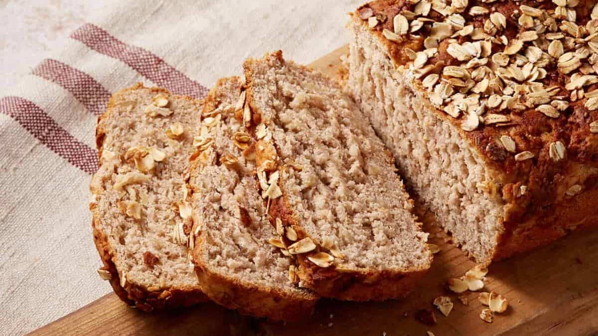 Apple oatmeal brad sliced on a wooden cutting board.