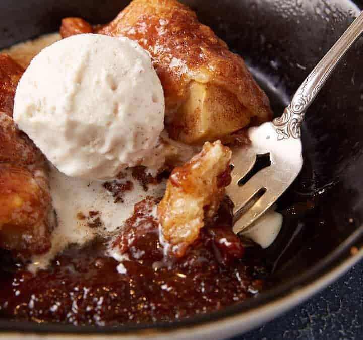 Apple Dumplings in a bowl with ice cream.