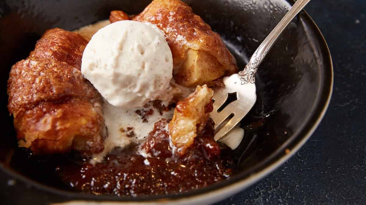 Apple Dumplings in a bowl with ice cream.