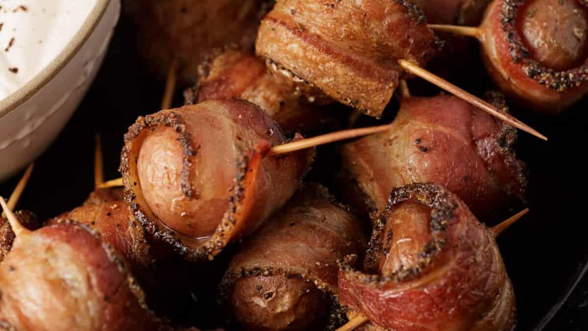 A platter of bacon wrapped potato bites.