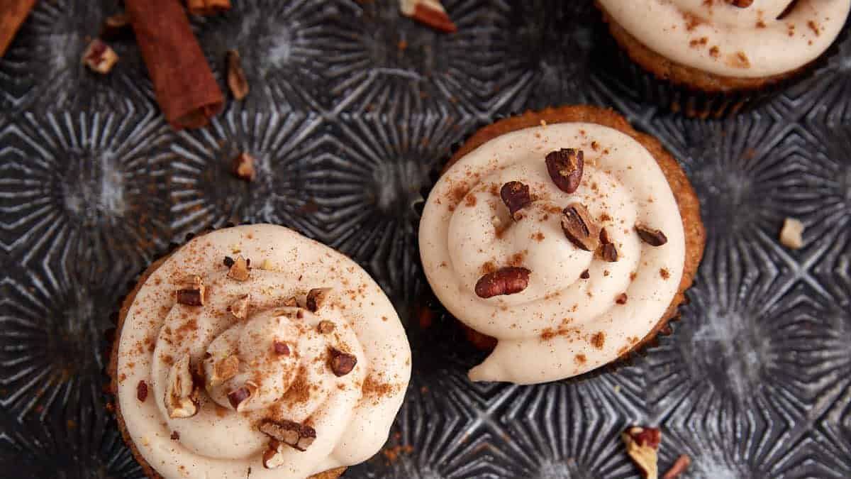 Carrot cake cupcakes on a serving tray.