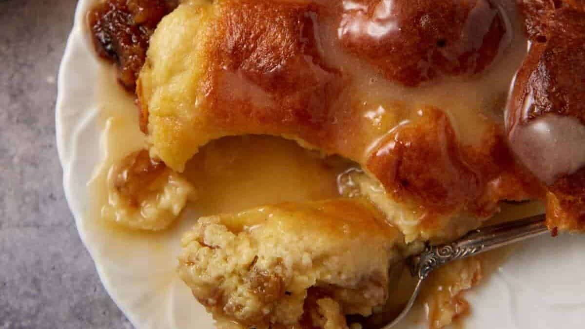 A serving of bread pudding with a spoon.