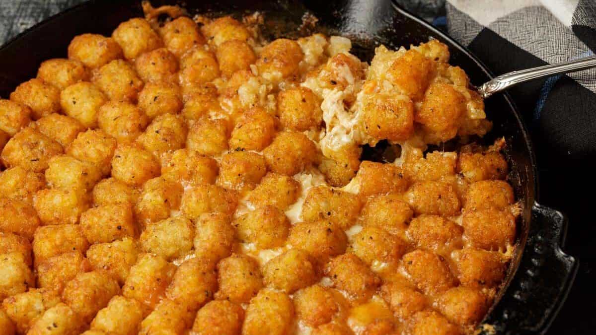 A serving being taken from a chicken casserole.