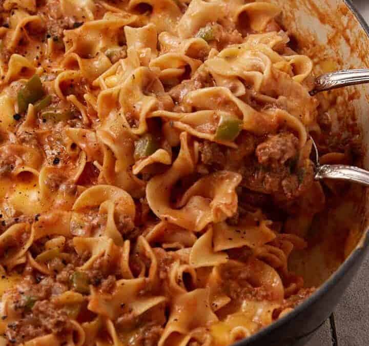 A pot of Johnny Marzetti with two serving spoons.