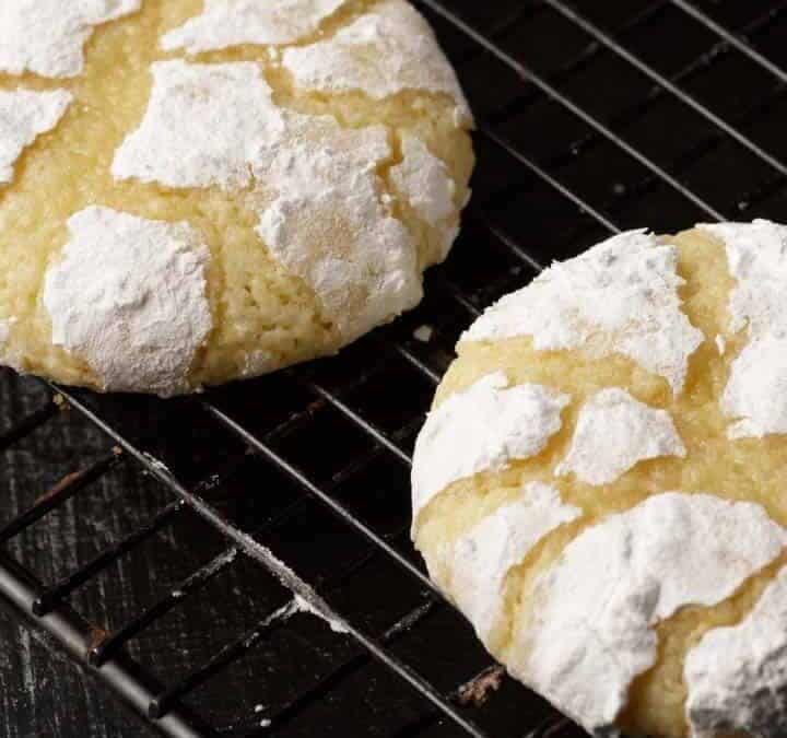 Lemon crinkle cookies on a cooling rack.