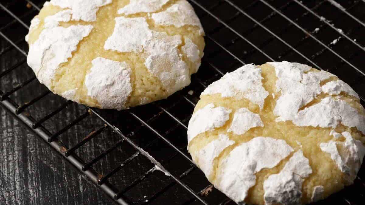 Lemon crinkle cookies on a cooling rack.