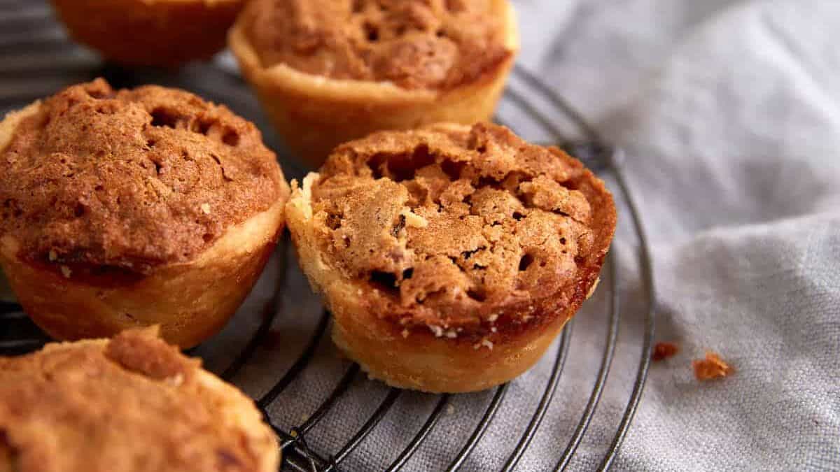 Pecan tarts on a rack.