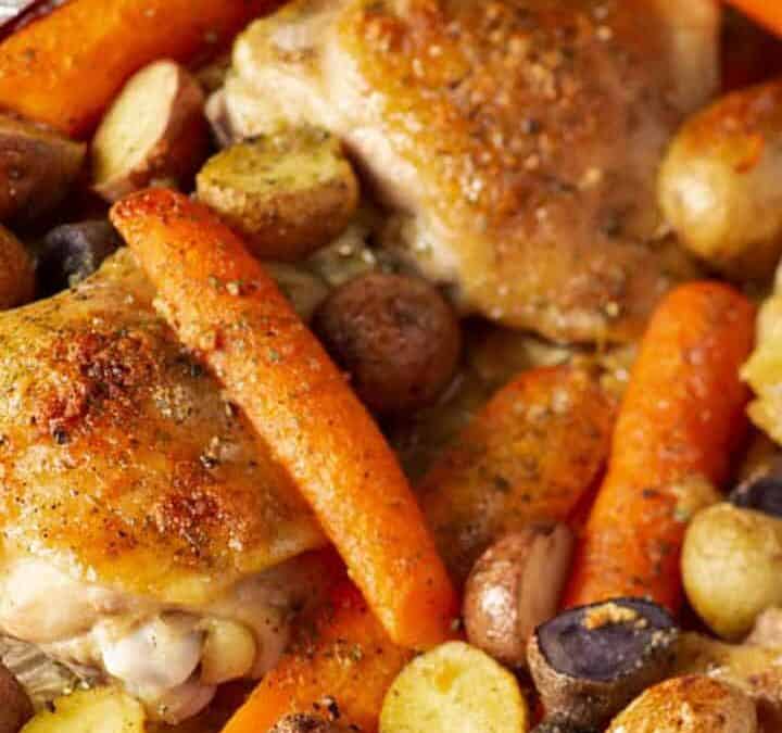 Ranch chicken on a sheet pan with carrots and potaotes.