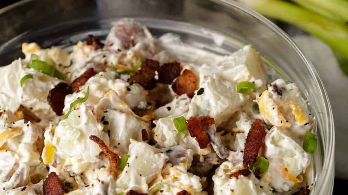 A glass bowl of potato salad with Ranch dressing.