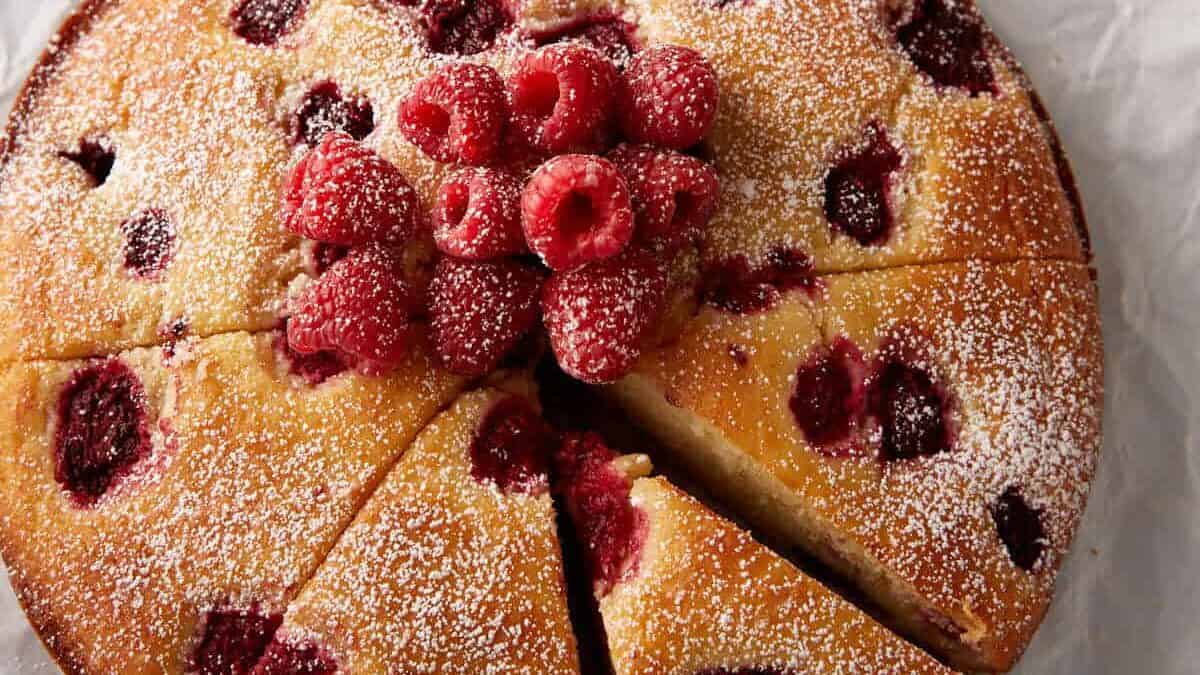 A raspberry ricotta cake sprinkled with powdered sugar.