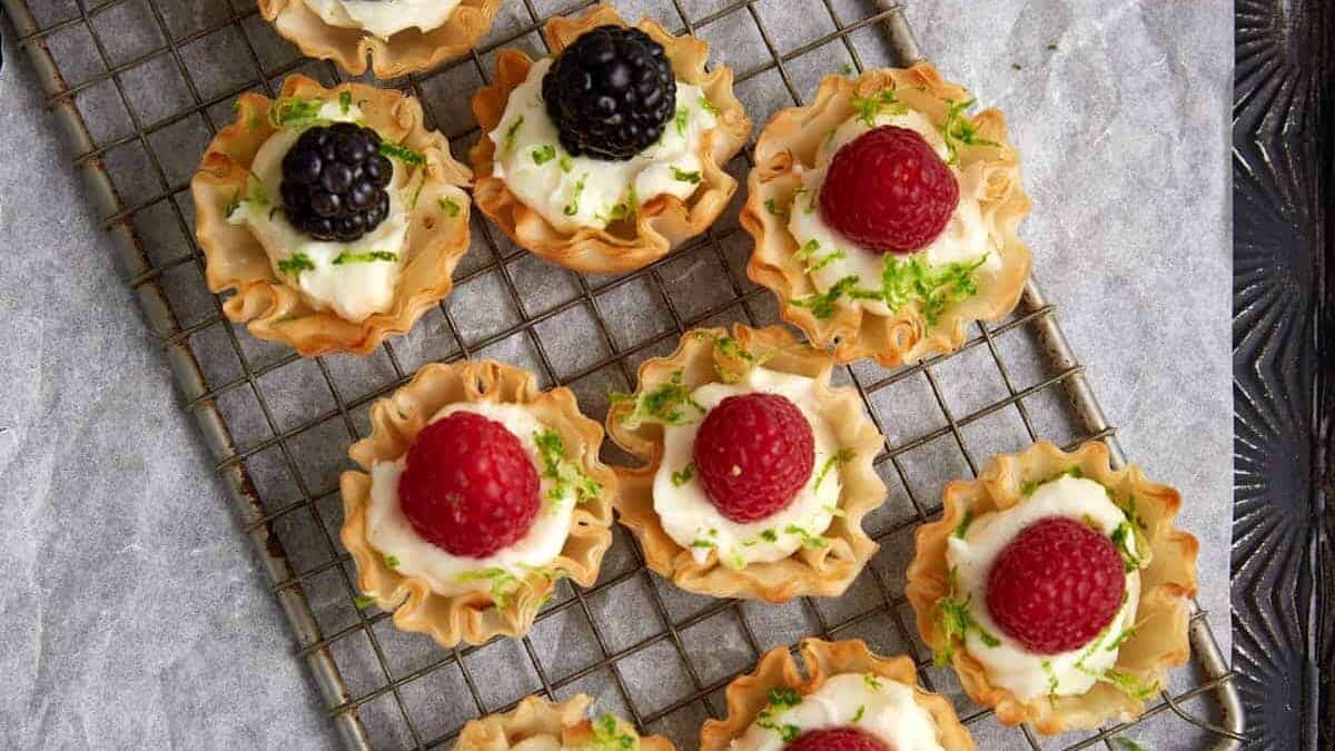 A tray of raspberry tarts in phyllo cups.