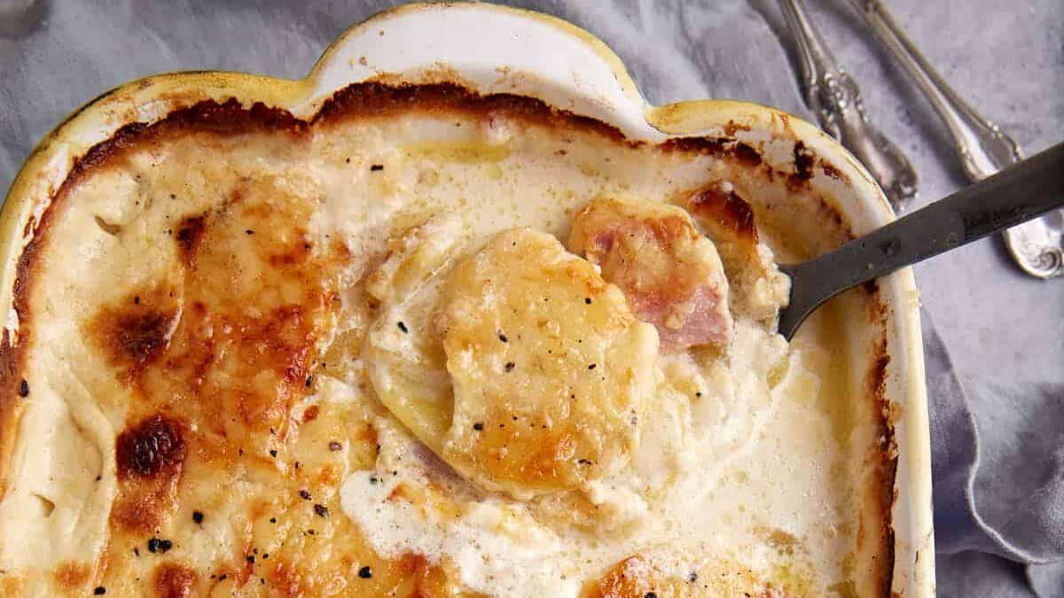 A casserole dish of scalloped potatoes and ham.