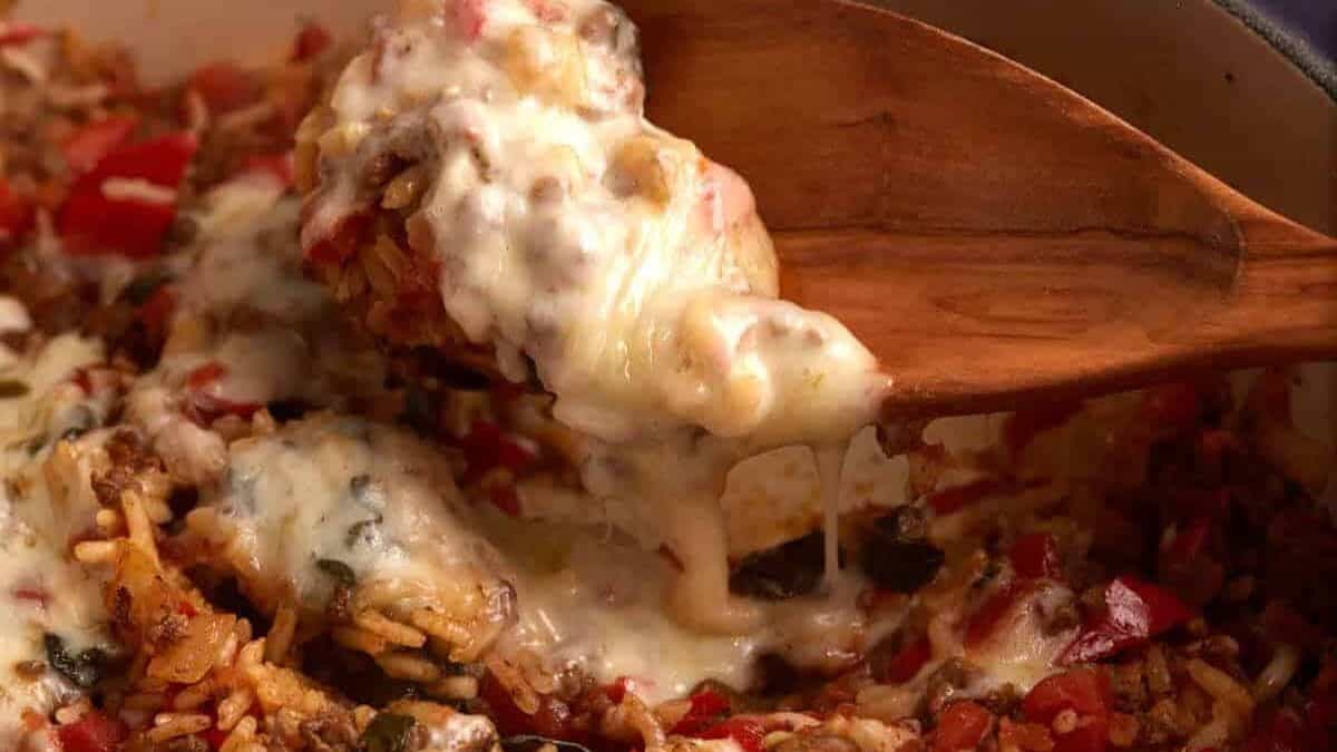Skillet Hamburger and Rice casserole with a wooden spoon.
