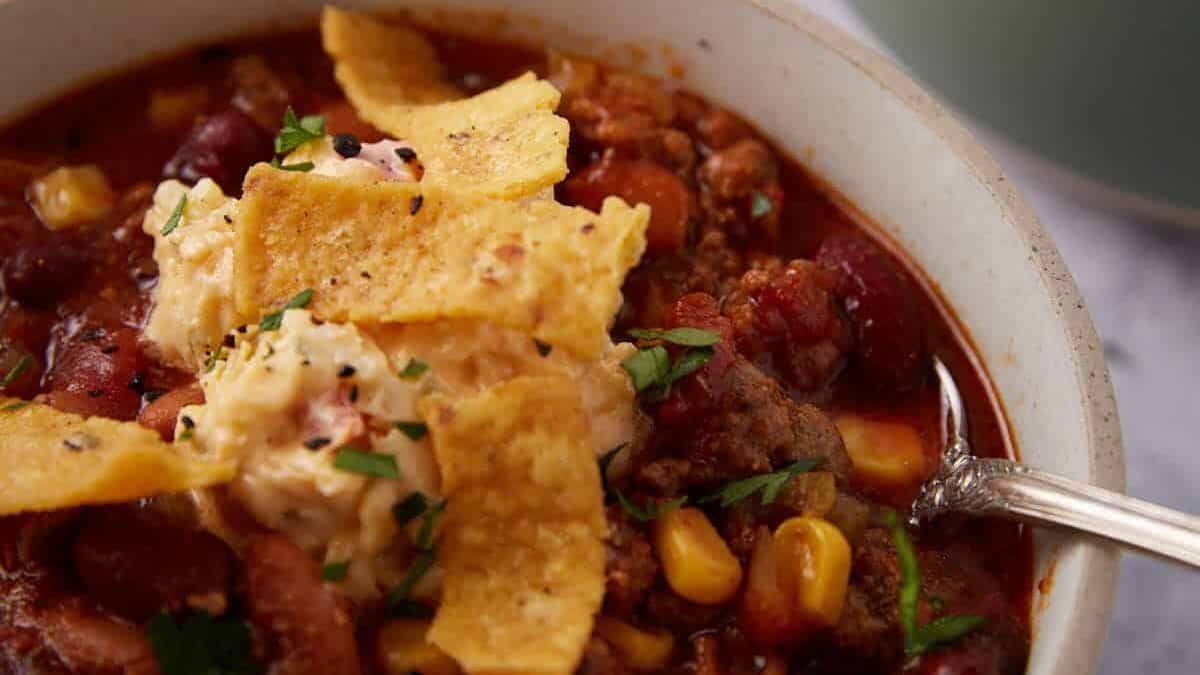 A bowl of crock pot taco soup with corn chips.
