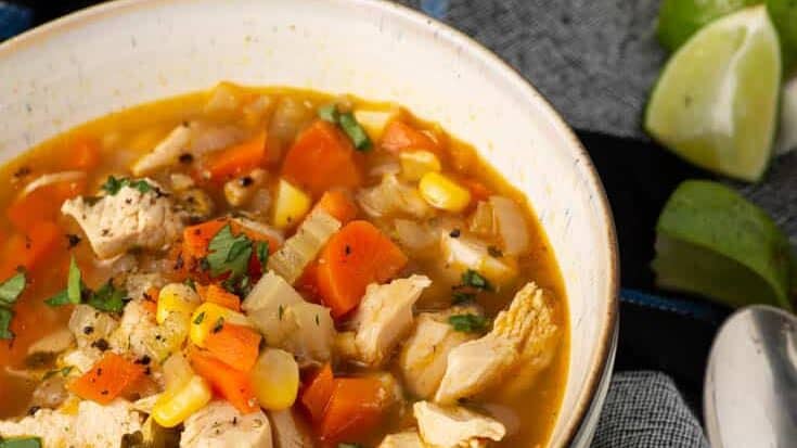A bowl of chicken soup with coriander