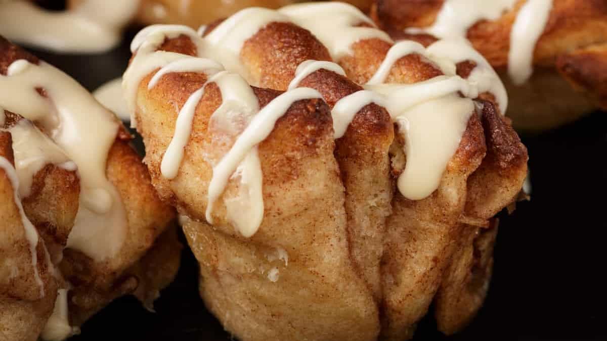 Frosted apple cinnamon rolls on a platter