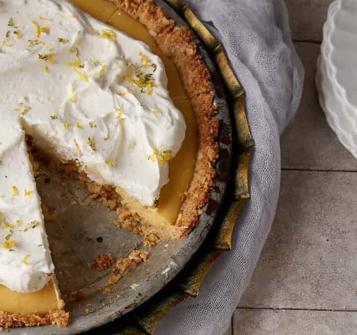 A slice of pie next to an entire pie.
