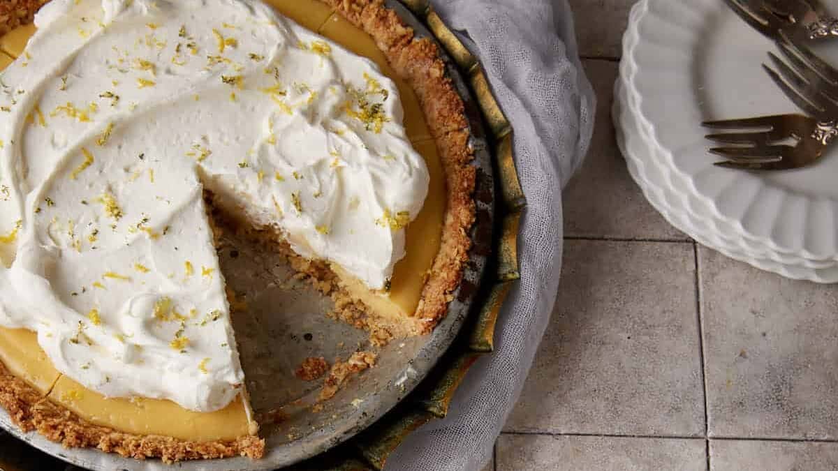 A slice of pie next to an entire pie.
