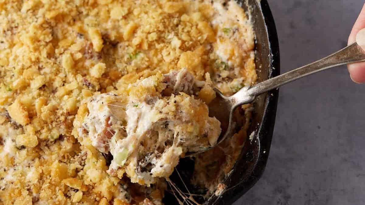 A scoop of bacon dip on a spoon.