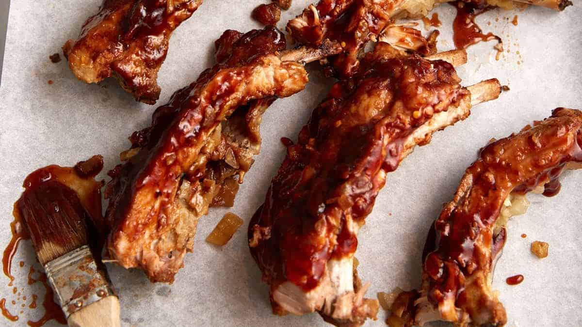 Individual pork ribs on parchment paper.